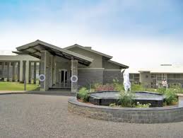 Modern office building with landscaped entry and fountain.