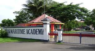 A peaceful view of the Maritime Academy entrance with trees and a small guard post.