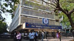 Group of professionals standing outside a government building signage, signifying employment opportunities.