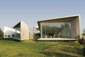 Contemporary commercial building with glass facades and green surroundings for business and retail use.