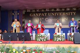 Students and faculty celebrating graduation at Ganpat University convocation ceremony.
