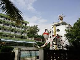 Large outdoor playground with climbing structures and slides in a green park setting.